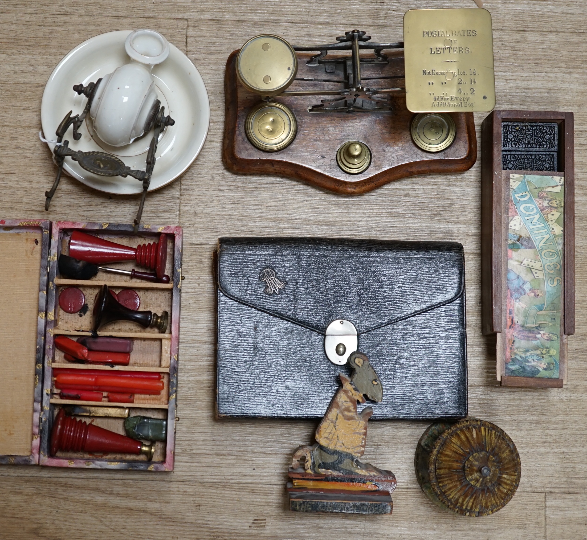 A pair of brass letter scales, a novelty ink pot, a Gladstone bag, a maple framed sketch, a googlie eyed doll’s head, a tin plate Jumbo toy, Dominoes, boxed seal kit and a leather travelling stationary case etc., scales